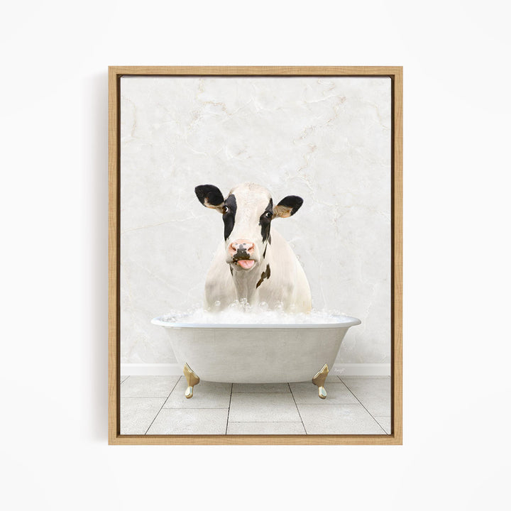 A black and white cow is sitting in a white bathtub filled with water, creating a whimsical and humorous scene.