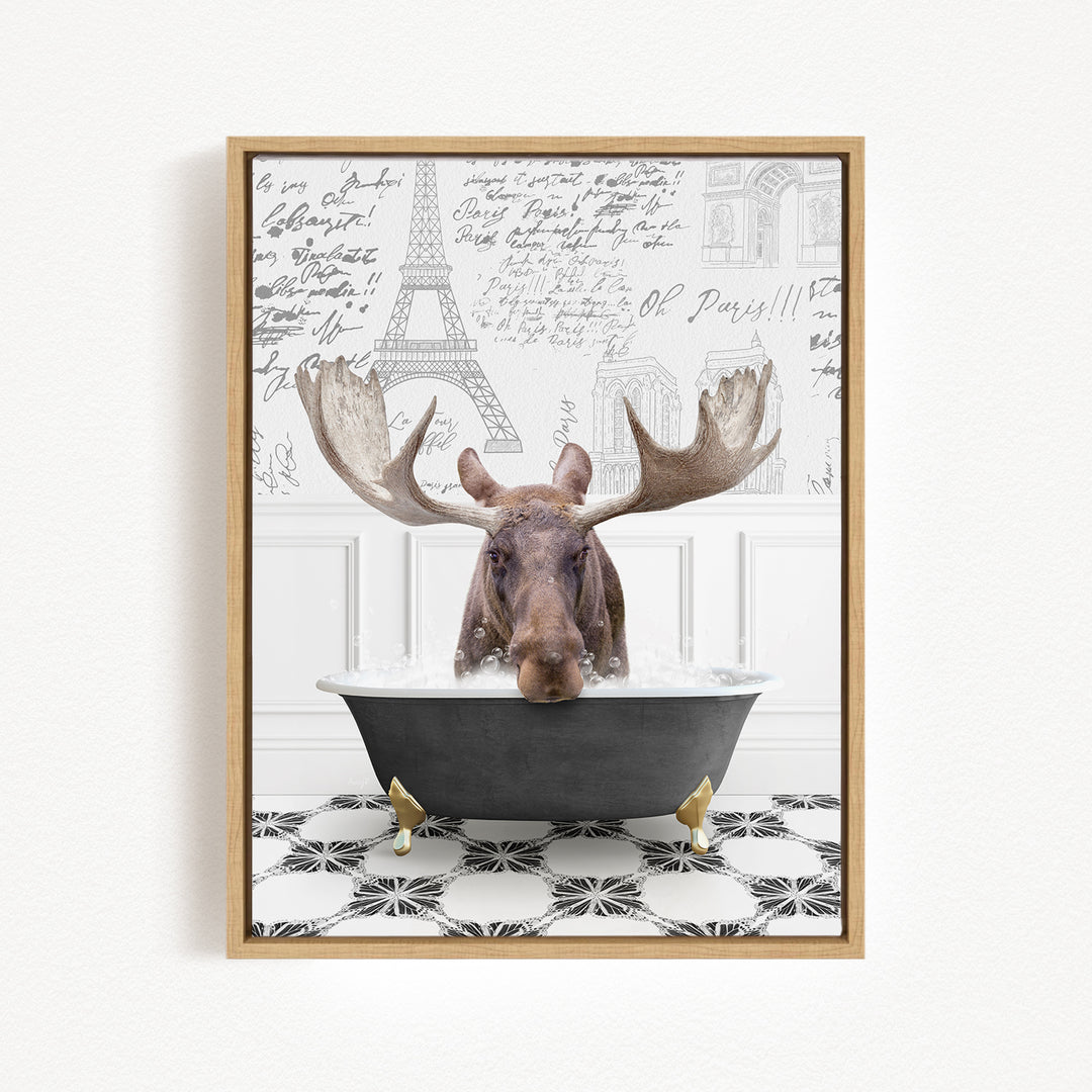 A moose with large antlers is sitting in a bathtub filled with water, surrounded by a patterned floor and a wall with the Eiffel Tower and other Parisian landmarks.