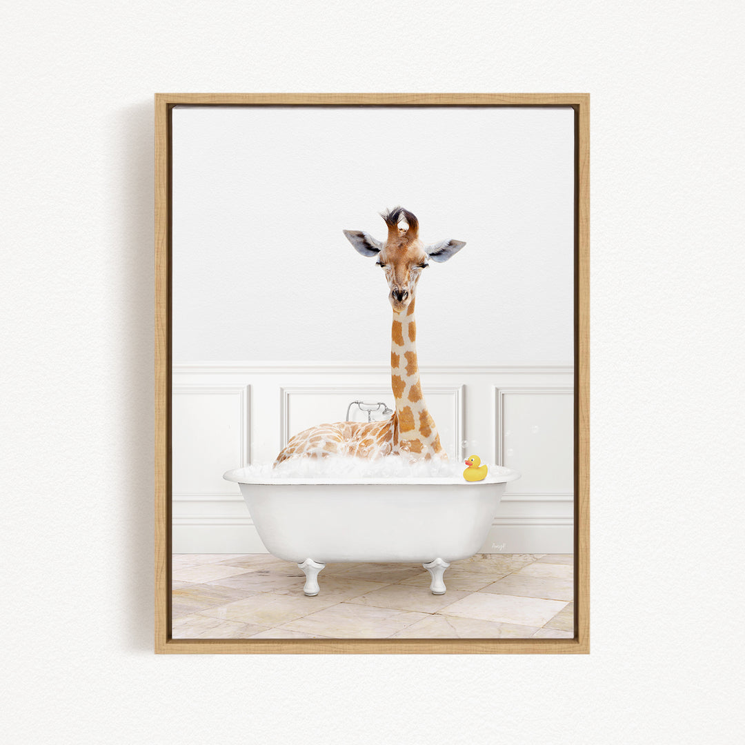 A giraffe sitting in a white bathtub filled with bubbles, with a yellow rubber duck floating in the water.