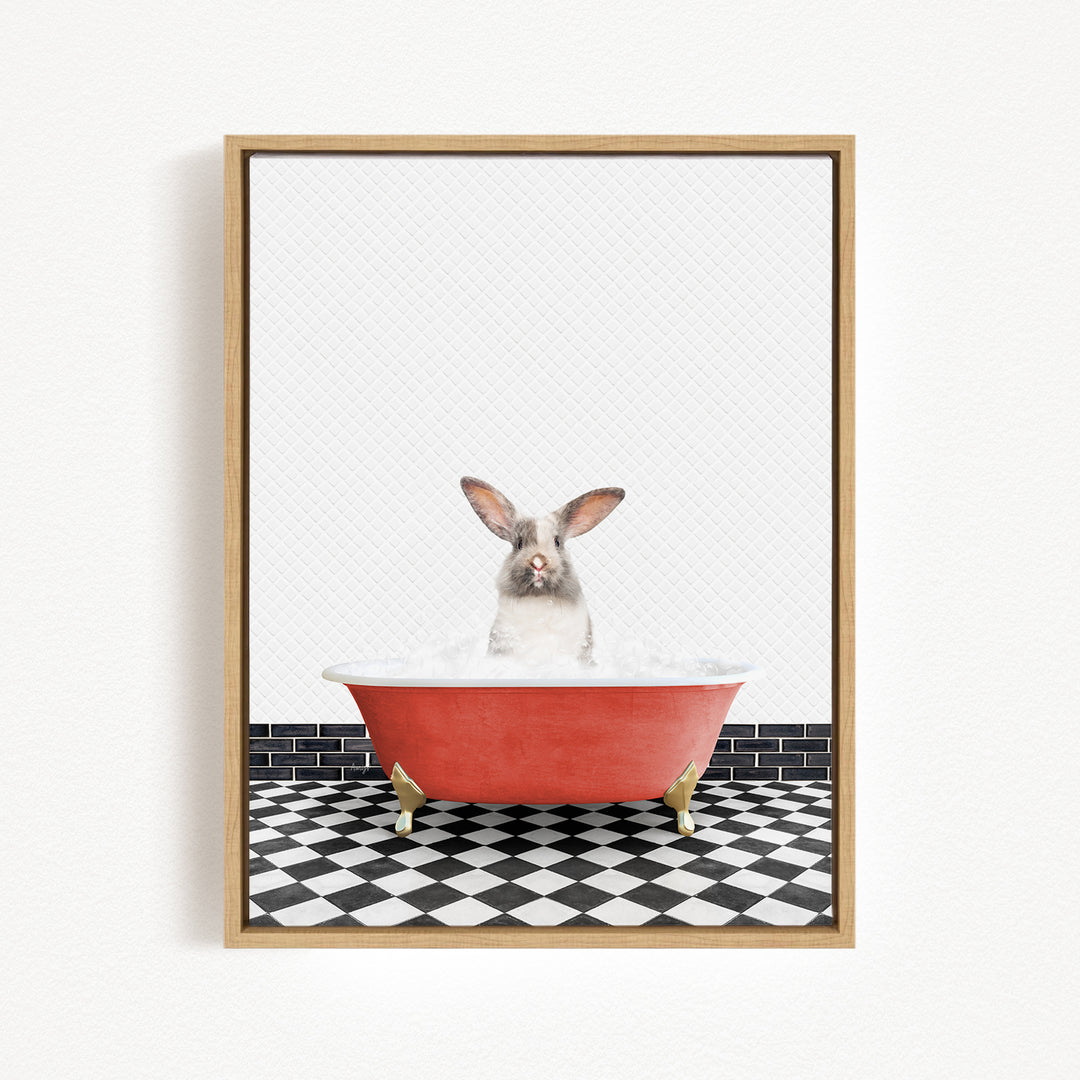 A gray and white rabbit sitting in a red bathtub filled with water, with a black and white checkered floor in the background.