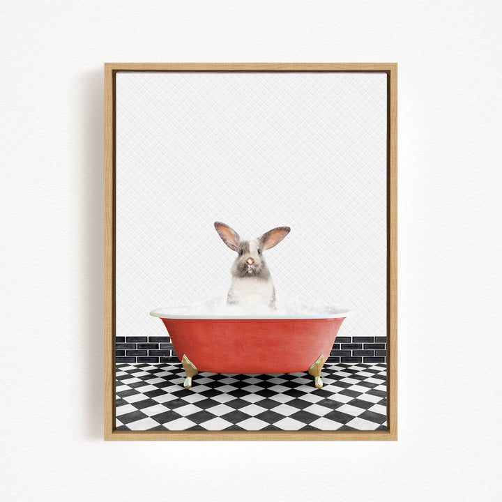 A gray and white rabbit sitting in a red bathtub filled with water, with a black and white checkered floor in the background.