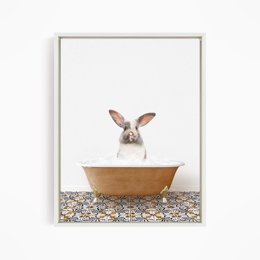 A white rabbit sitting in a bathtub filled with water, looking directly at the camera.