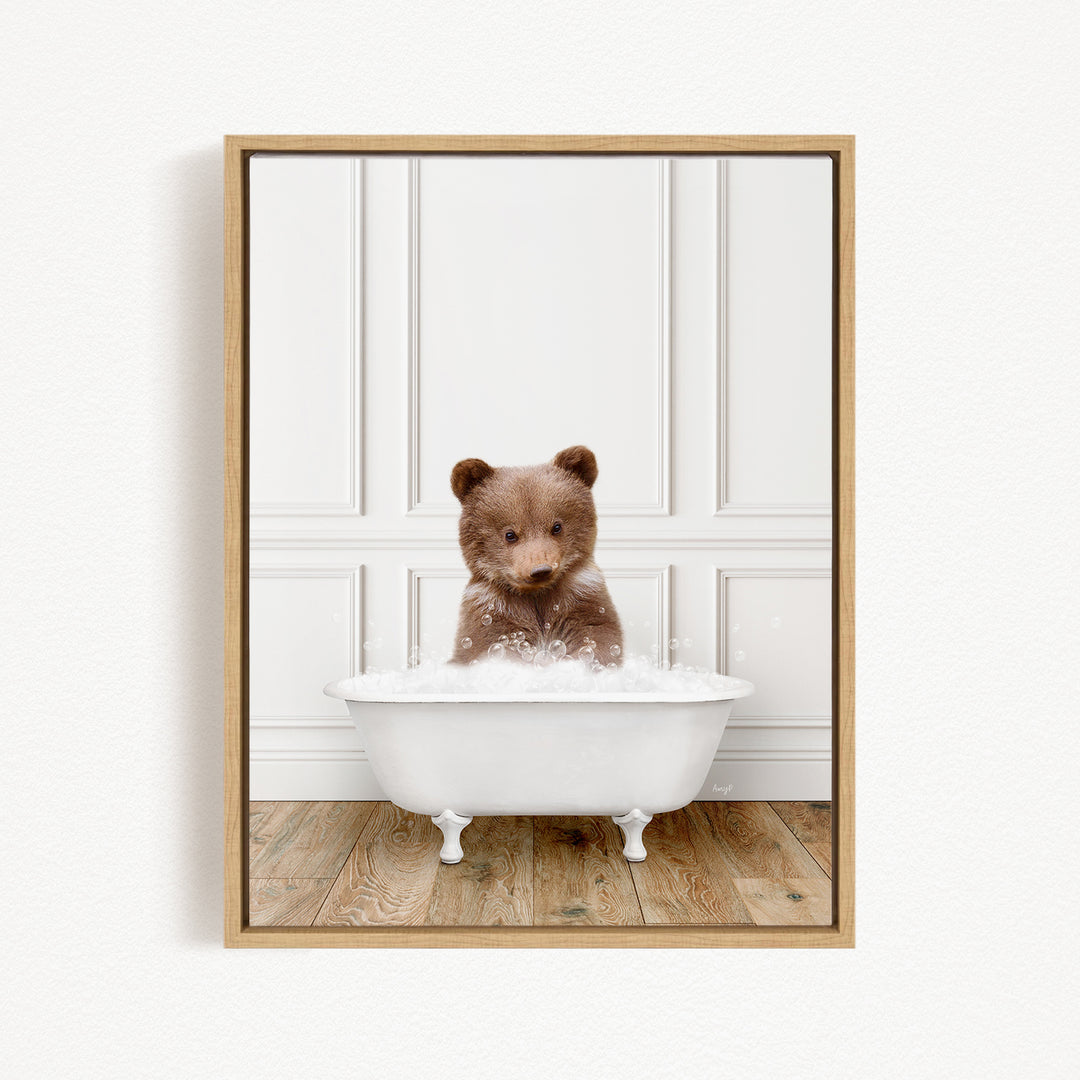 A brown bear sitting in a white bathtub filled with bubbles, looking up at the camera.