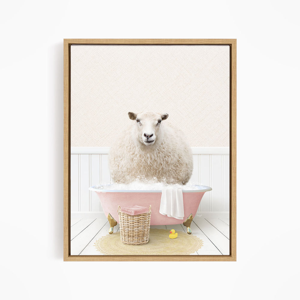 A fluffy white sheep sits in a pink bathtub filled with bubbles, surrounded by a basket of bath toys and a yellow rubber duck.