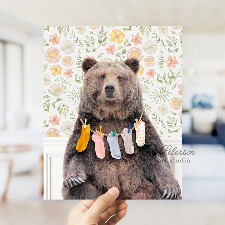 a person holding up a card with a picture of a bear