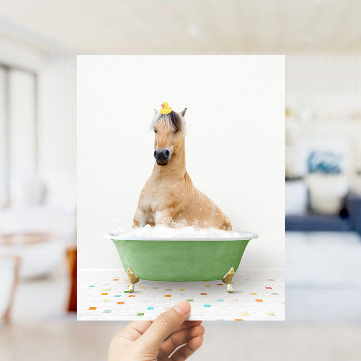 A horse sitting in a green bathtub filled with bubbles, wearing a yellow rubber duck on its head.