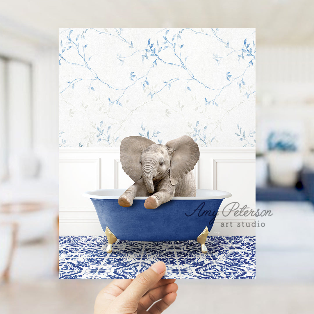 a person holding up a card with an elephant in a bathtub