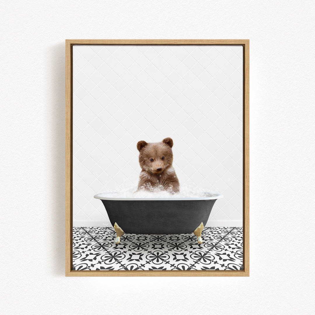 A brown bear sitting in a black bathtub filled with water, surrounded by a black and white patterned floor.