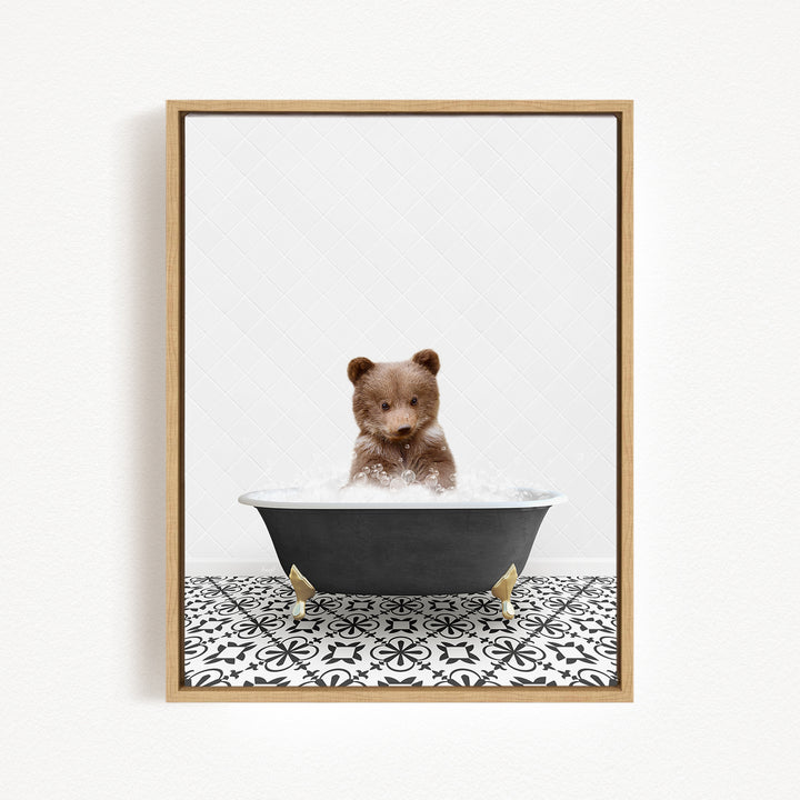 A brown bear sitting in a black bathtub filled with water, surrounded by a black and white patterned floor.