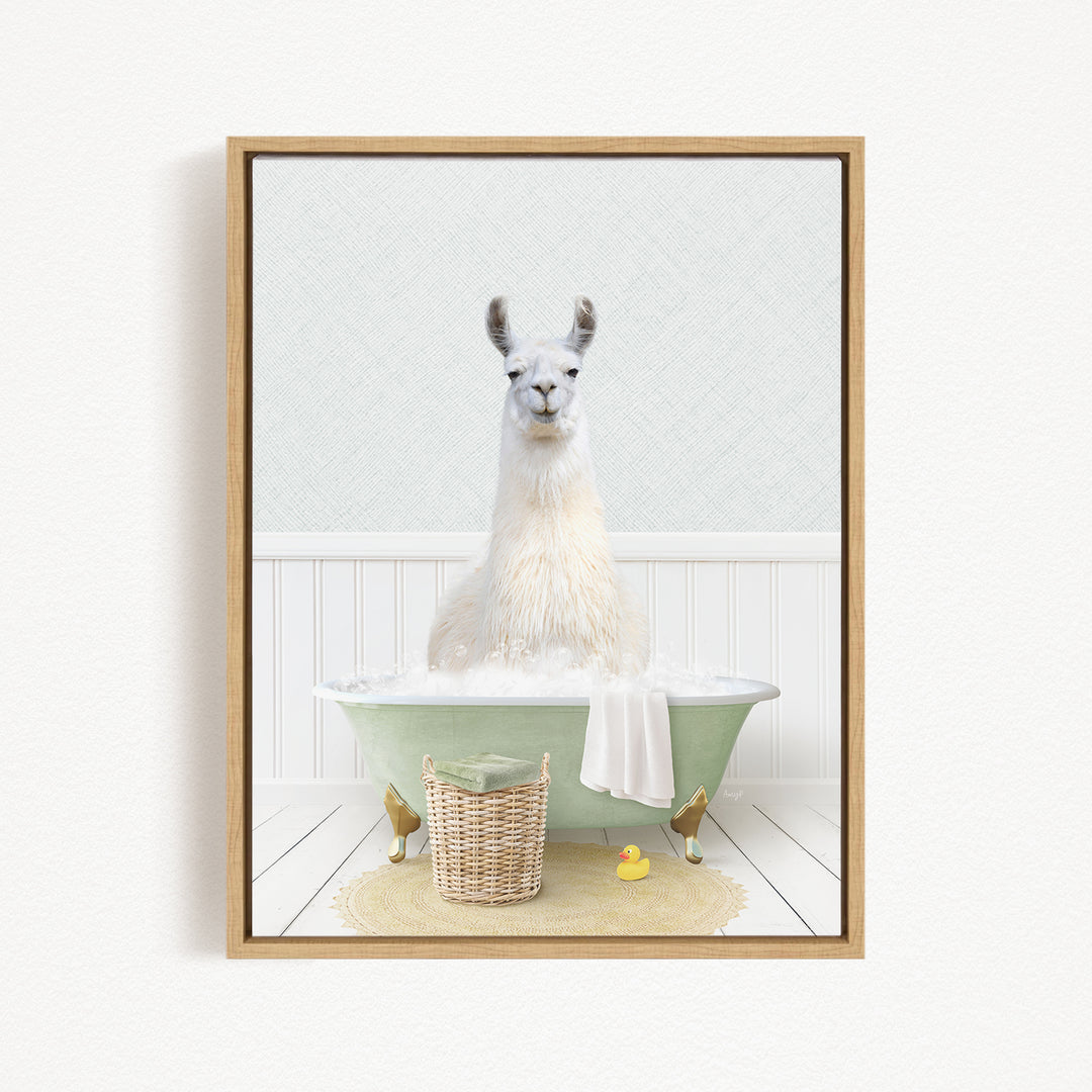 A white llama sitting in a green bathtub filled with bubbles, surrounded by a basket of toys and a yellow rubber duck.