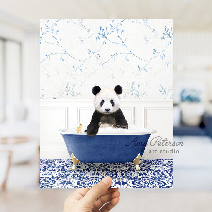 a hand holding a card with a panda bear in a bathtub