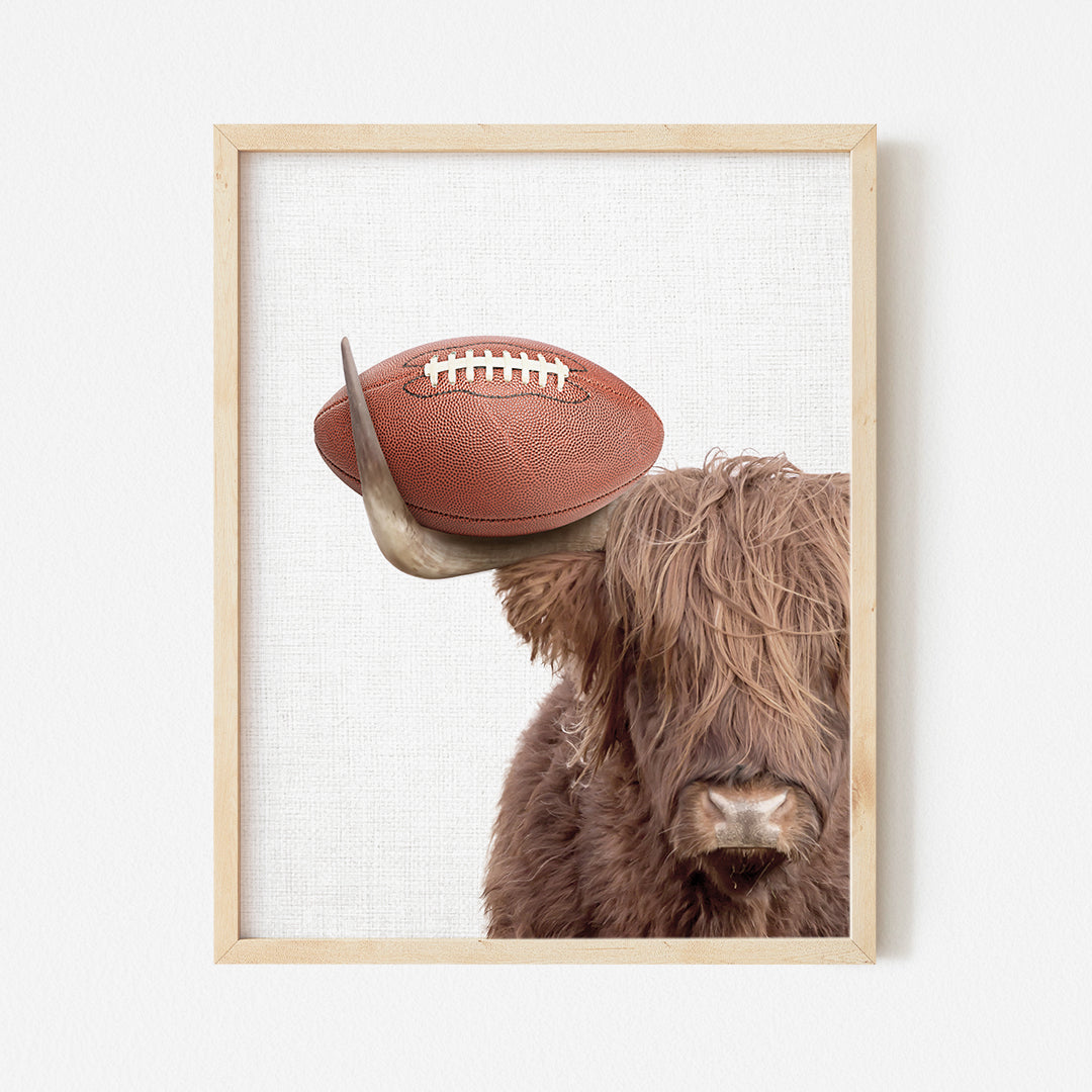 a picture of a bull with a football on its head