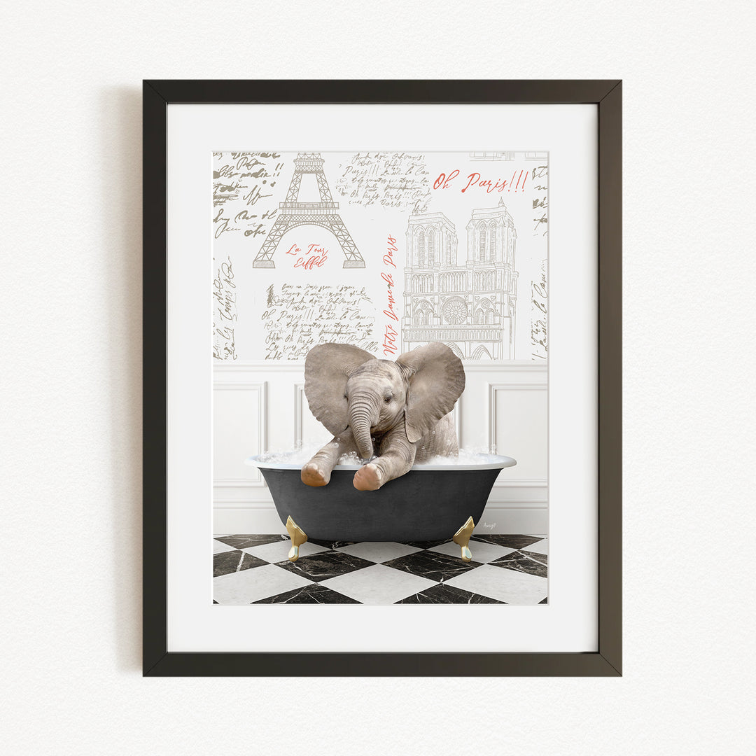 A framed image depicting a baby elephant sitting in a bathtub, with a Paris-themed background featuring the Eiffel Tower and other Parisian landmarks.