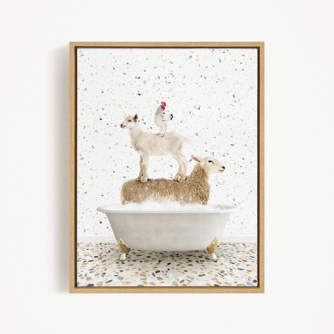 A framed image depicting a goat standing on a sheep in a bathtub, with a chicken perched on top of the sheep.