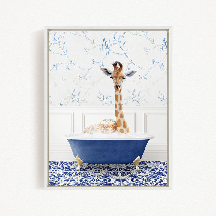 A giraffe is sitting in a blue bathtub, surrounded by a patterned tile floor and a floral wallpaper background.