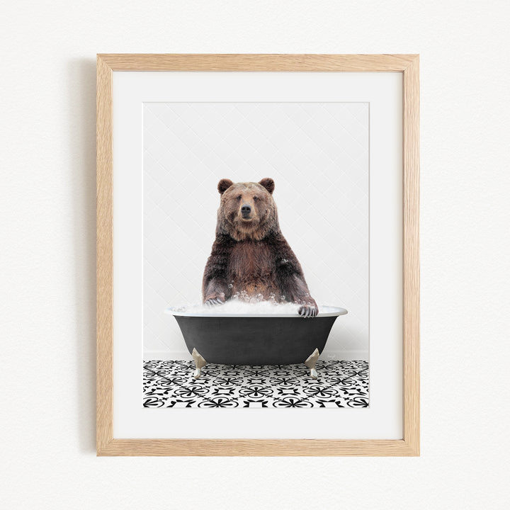 A brown bear sitting in a black bathtub filled with water, surrounded by a black and white patterned floor.