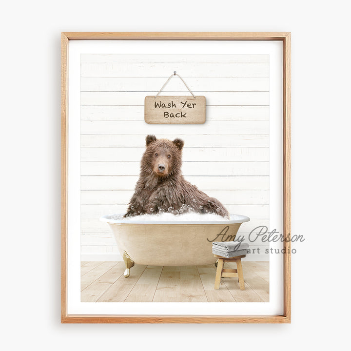 a brown bear sitting in a bathtub with a sign above it