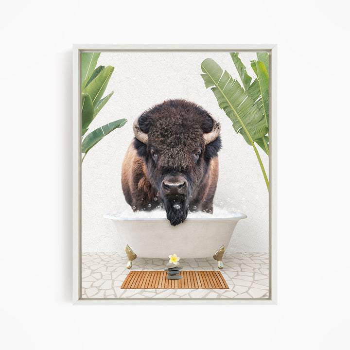 A buffalo is sitting in a bathtub filled with water, surrounded by tropical plants and a wooden mat on the floor.