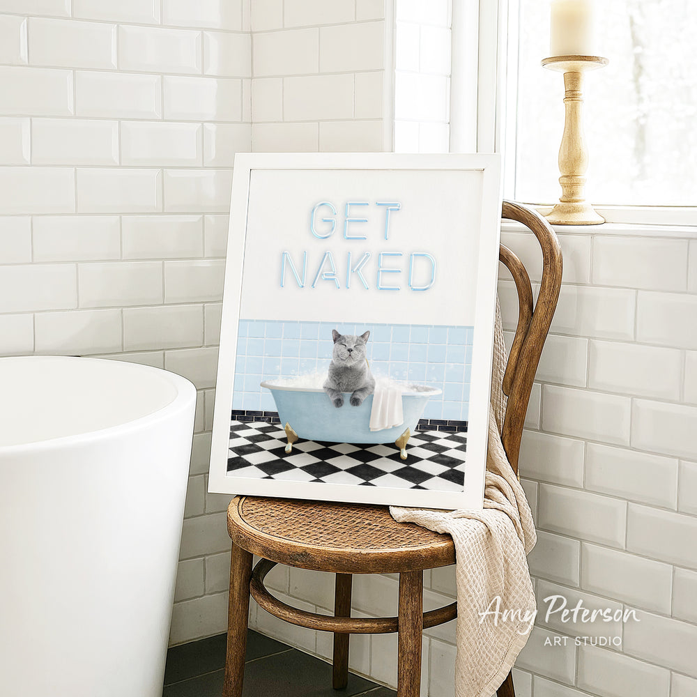 A framed image of a cat sitting in a bathtub, with the text "GET NAKED" displayed on the frame.