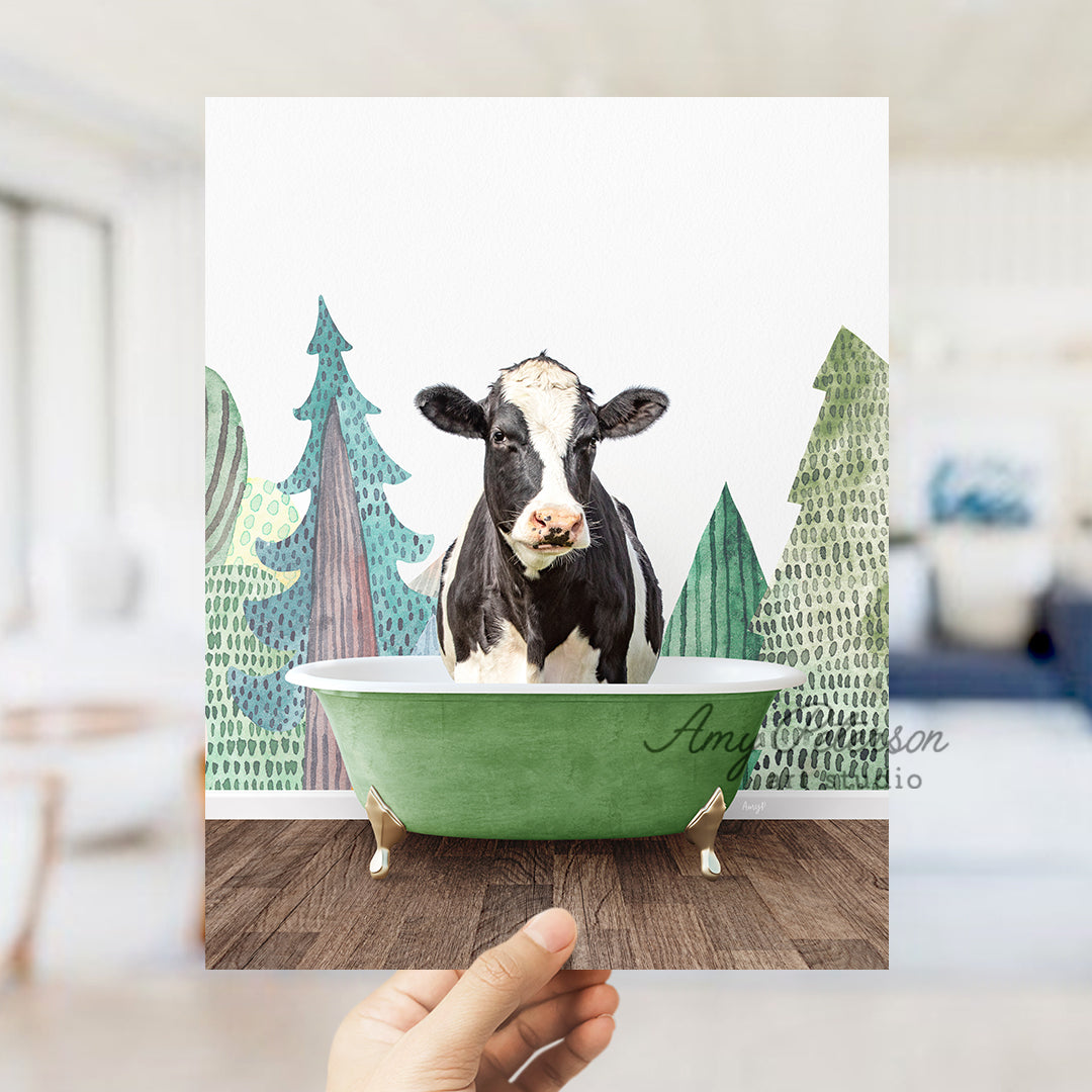 a hand holding up a card with a picture of a cow in a bathtub