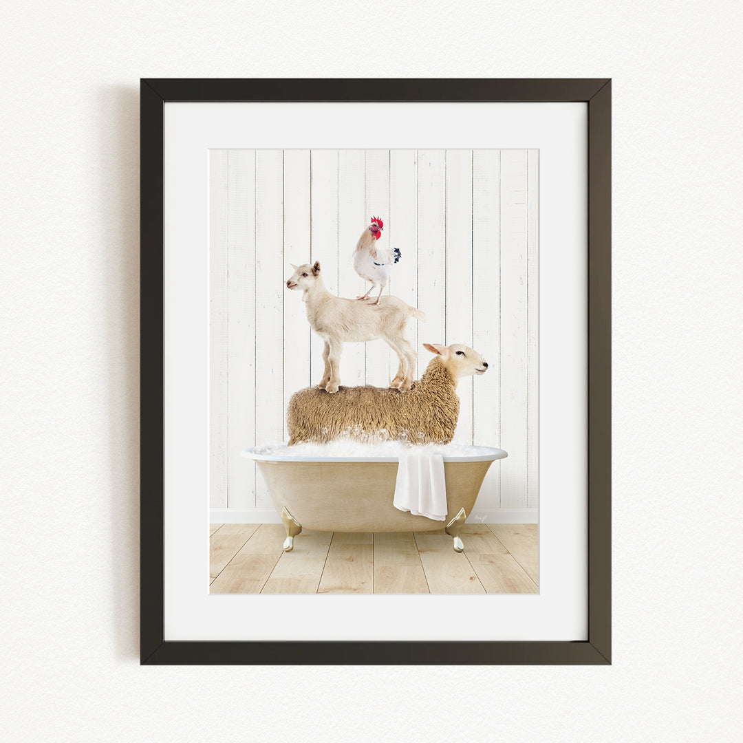 A framed image depicting a goat standing on a sheep's back while a chicken sits on top of a sheep in a bathtub.