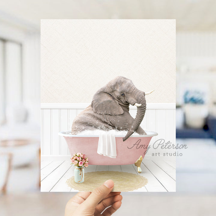 a person holding up a picture of an elephant in a bathtub