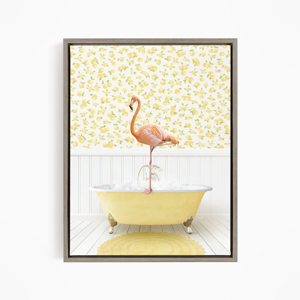 A pink flamingo stands on the edge of a yellow clawfoot bathtub, with a yellow and white floral wallpaper in the background.
