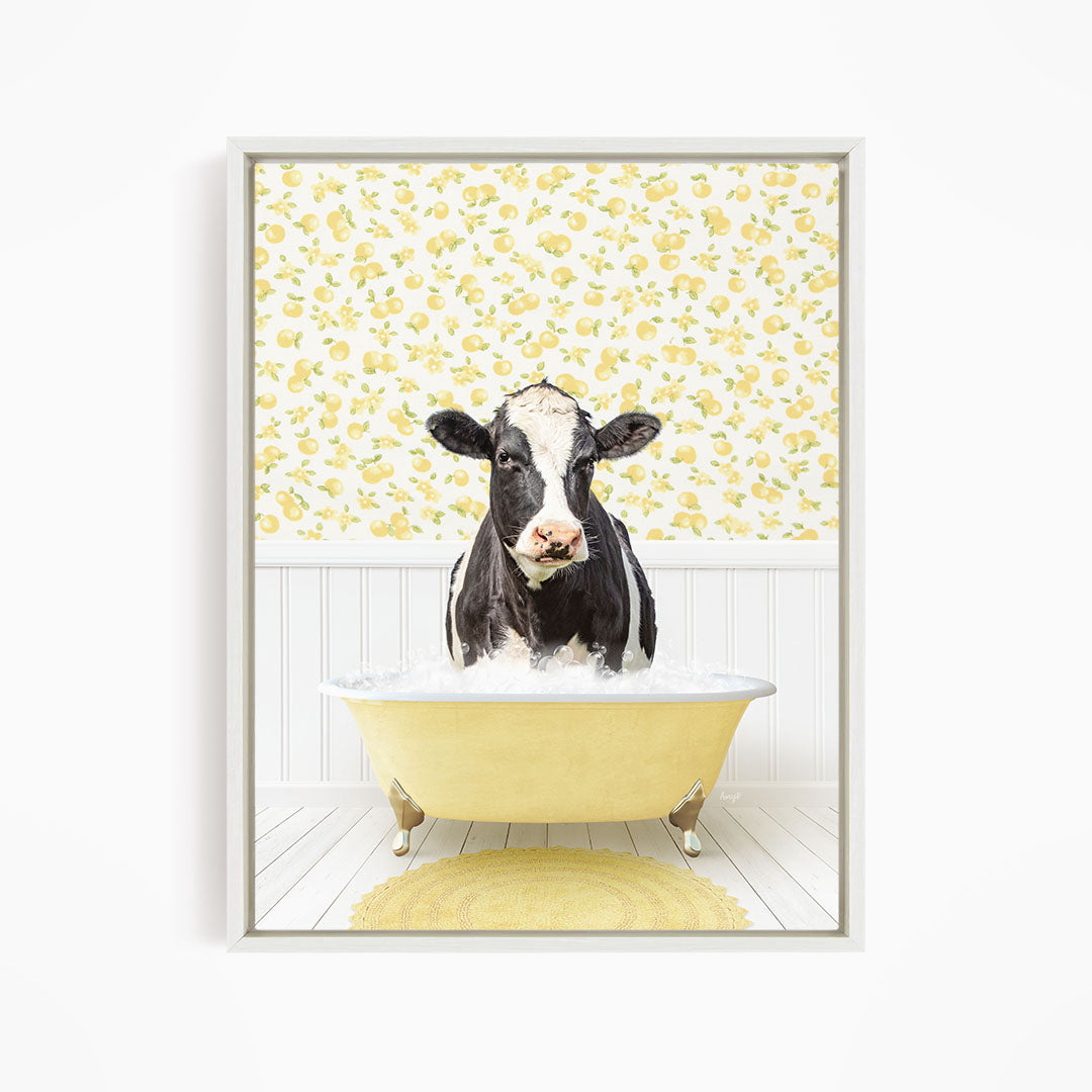 A black and white cow is sitting in a yellow bathtub filled with water, surrounded by a yellow floral pattern on the wall behind it.