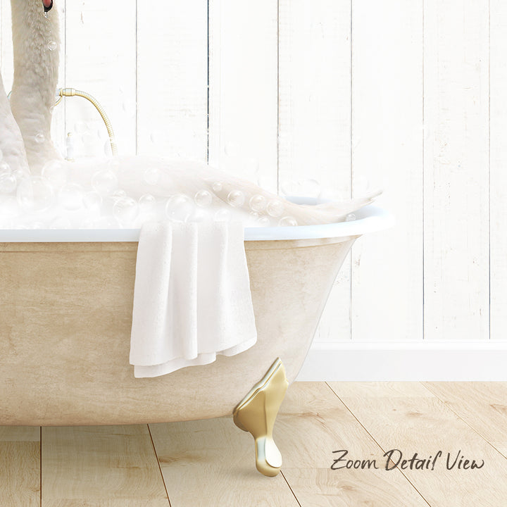 A person relaxing in a bathtub filled with bubbles, with a towel and gold bathtub faucet visible.