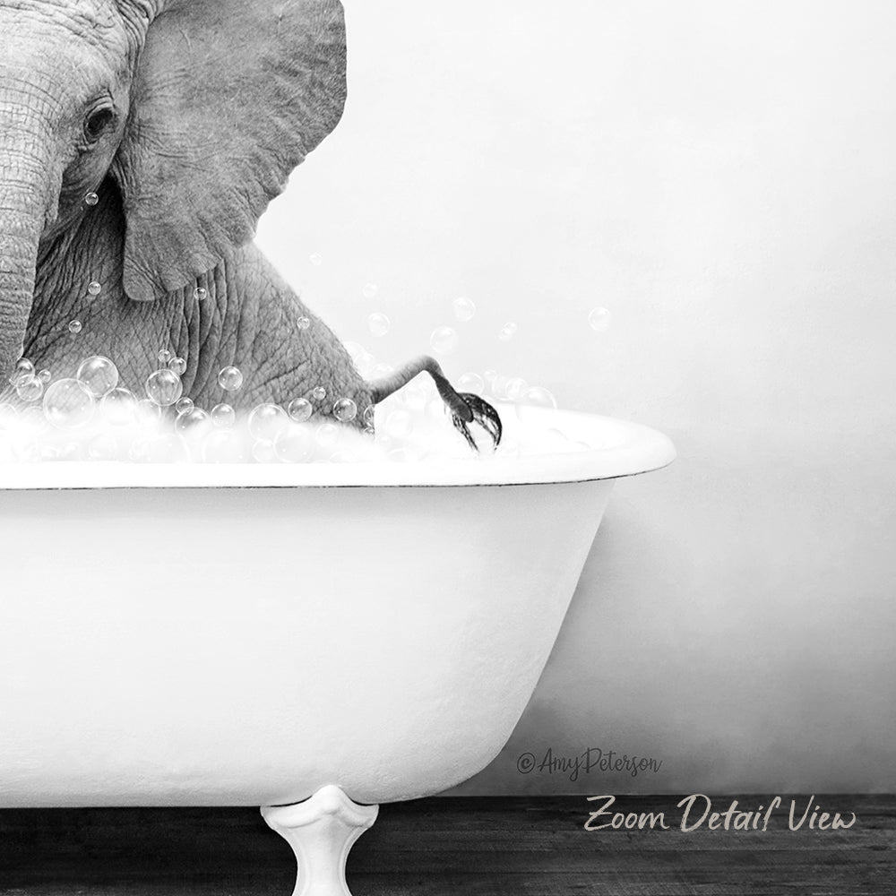 A large elephant is sitting in a bathtub filled with bubbles, creating a whimsical and playful scene.