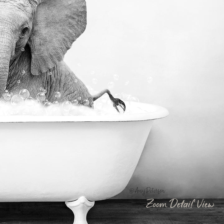 A large elephant is sitting in a bathtub filled with bubbles, creating a whimsical and playful scene.