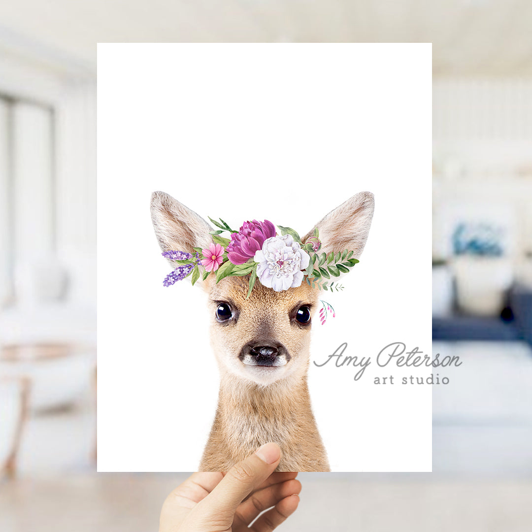 a person holding up a card with a picture of a deer wearing a flower crown