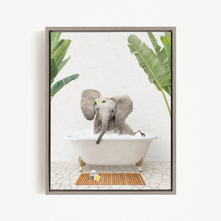A gray elephant is sitting in a white bathtub, surrounded by green leaves and a wooden mat, creating a whimsical and playful scene.
