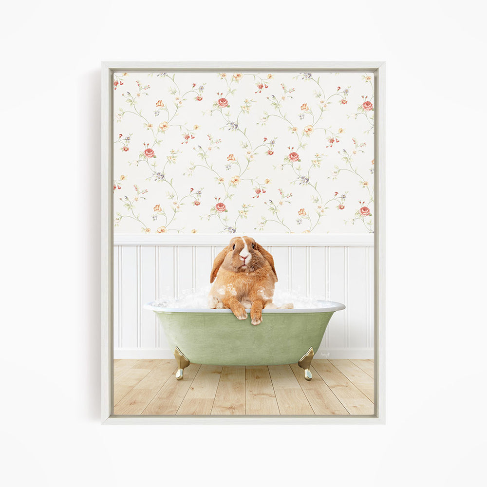 A brown rabbit sitting in a green bathtub filled with water, with a floral wallpaper in the background.