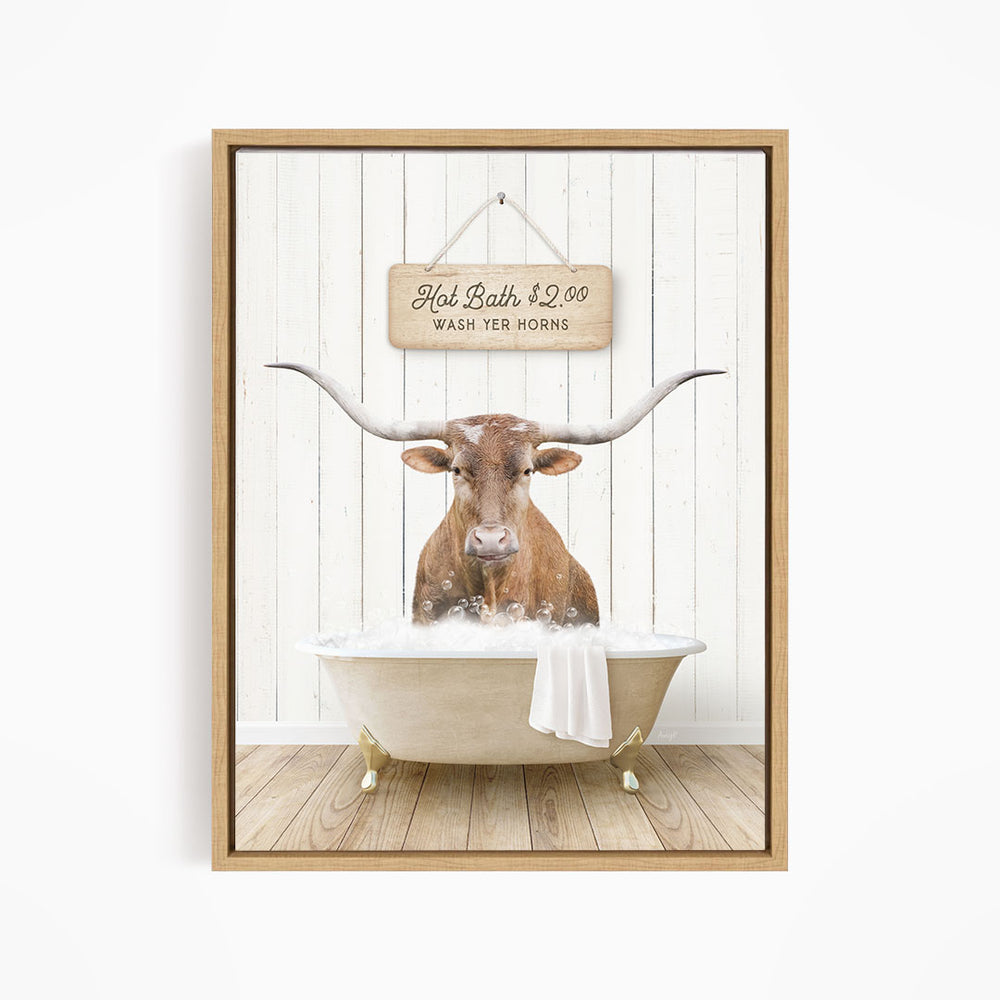 A framed image depicting a brown cow with large horns sitting in a bathtub, with a sign above the tub stating "Hot Bath $2.00 WASH YOUR HORSES".