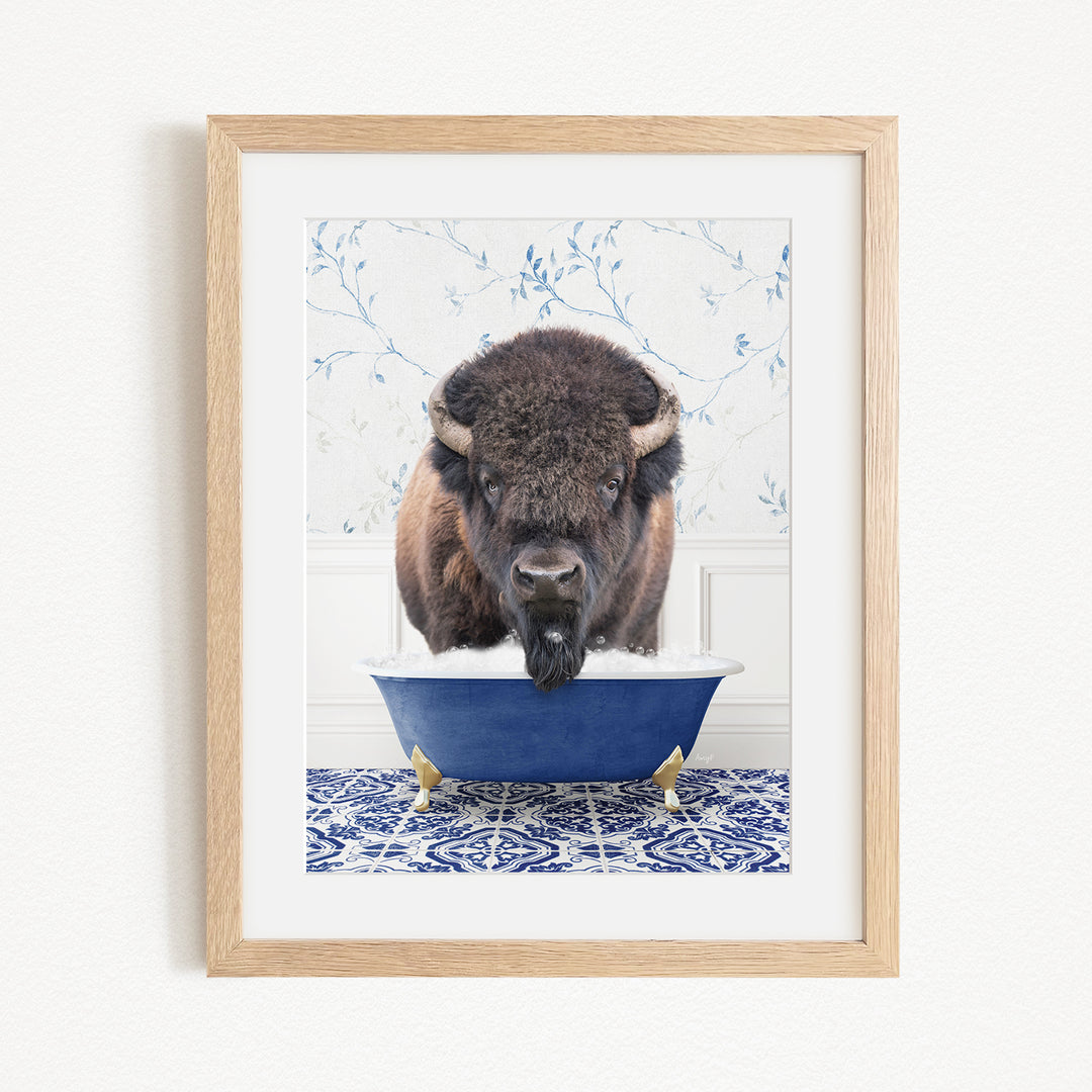A buffalo standing in a blue bathtub filled with water, with a patterned tile floor in the background.