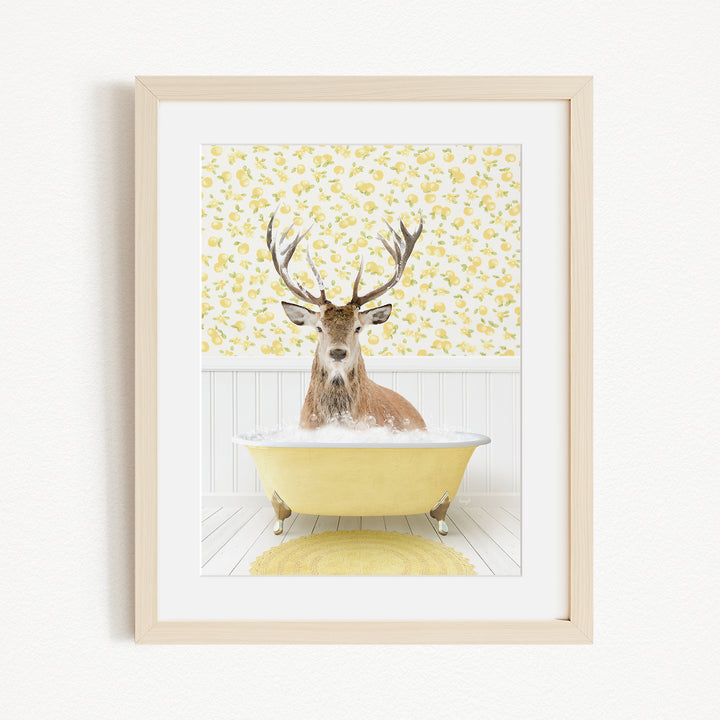 A deer with antlers is sitting in a yellow bathtub, surrounded by a yellow floral pattern on the wall behind it.