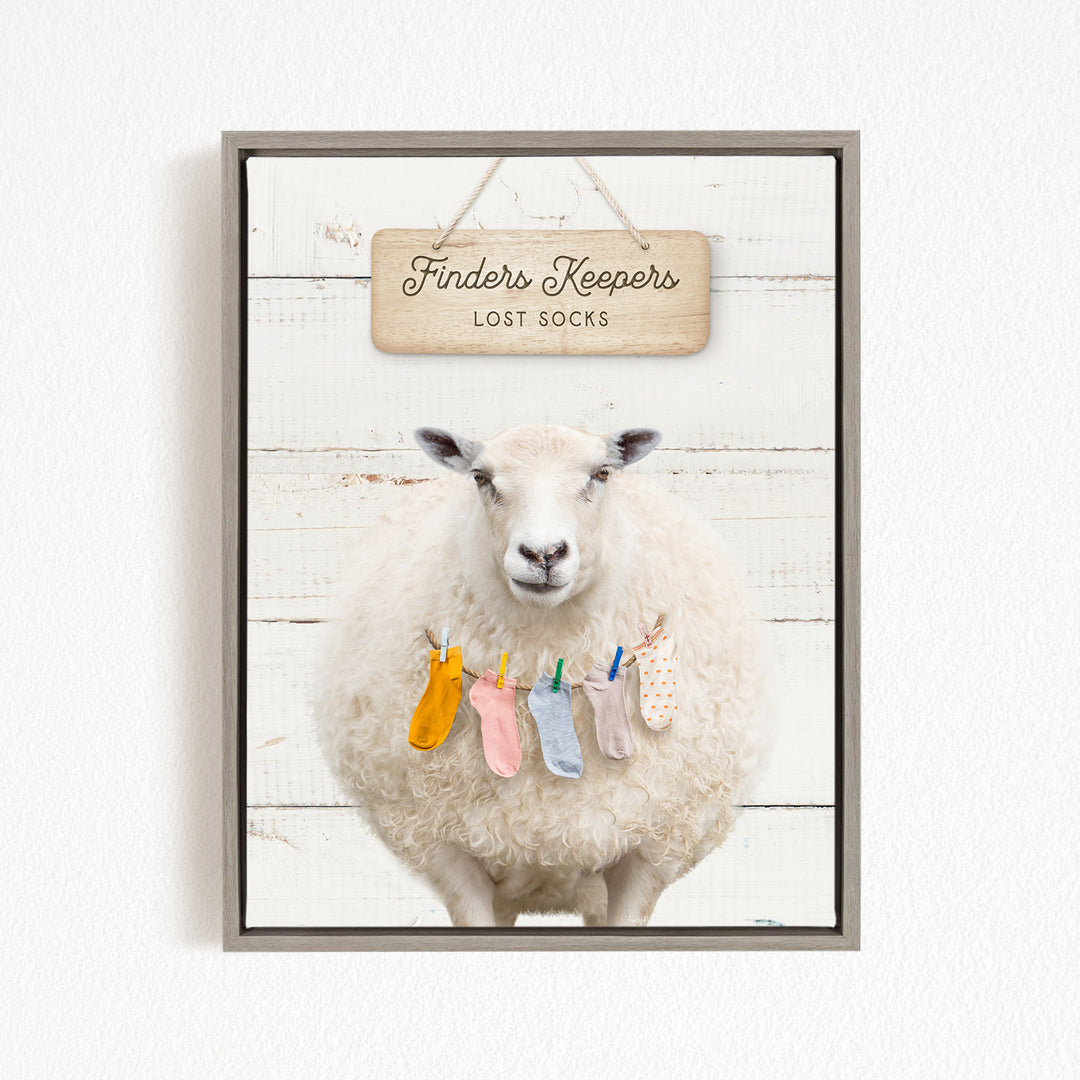 A white sheep with a sign that says "Finders Keepers" and "Lost Socks" hanging above it.