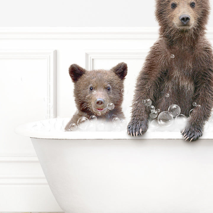 a couple of brown bears sitting in a bath tub