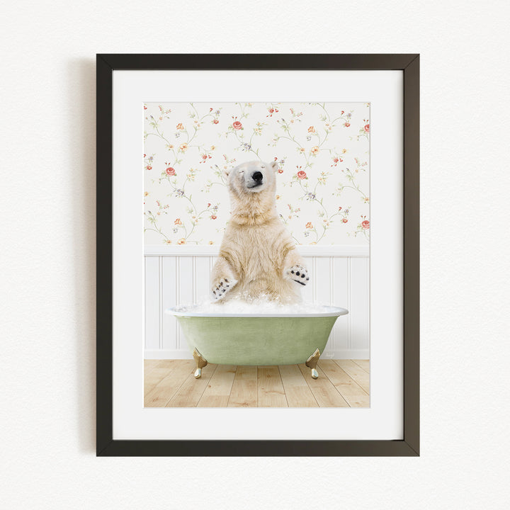 A polar bear sitting in a green bathtub filled with water, surrounded by a floral patterned wall.