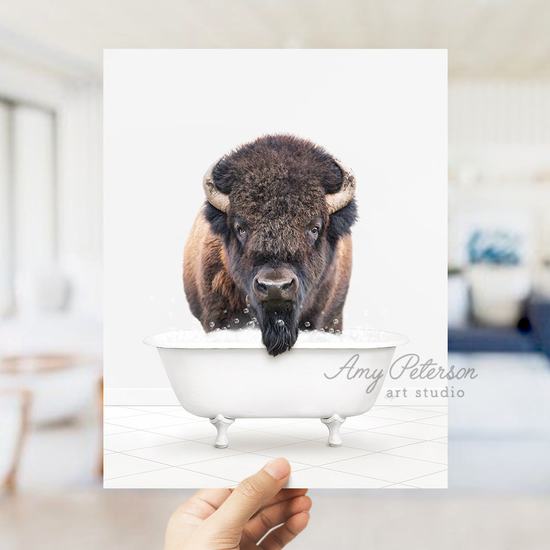 a person holding up a card with a picture of a bison in a bathtub