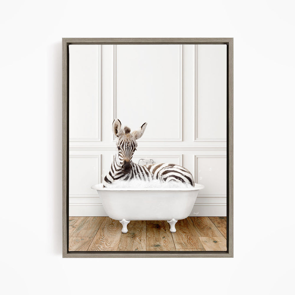 A zebra is sitting in a white bathtub, surrounded by a wooden floor and white walls.