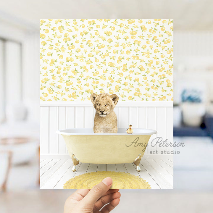 a person holding up a picture of a small animal in a bathtub