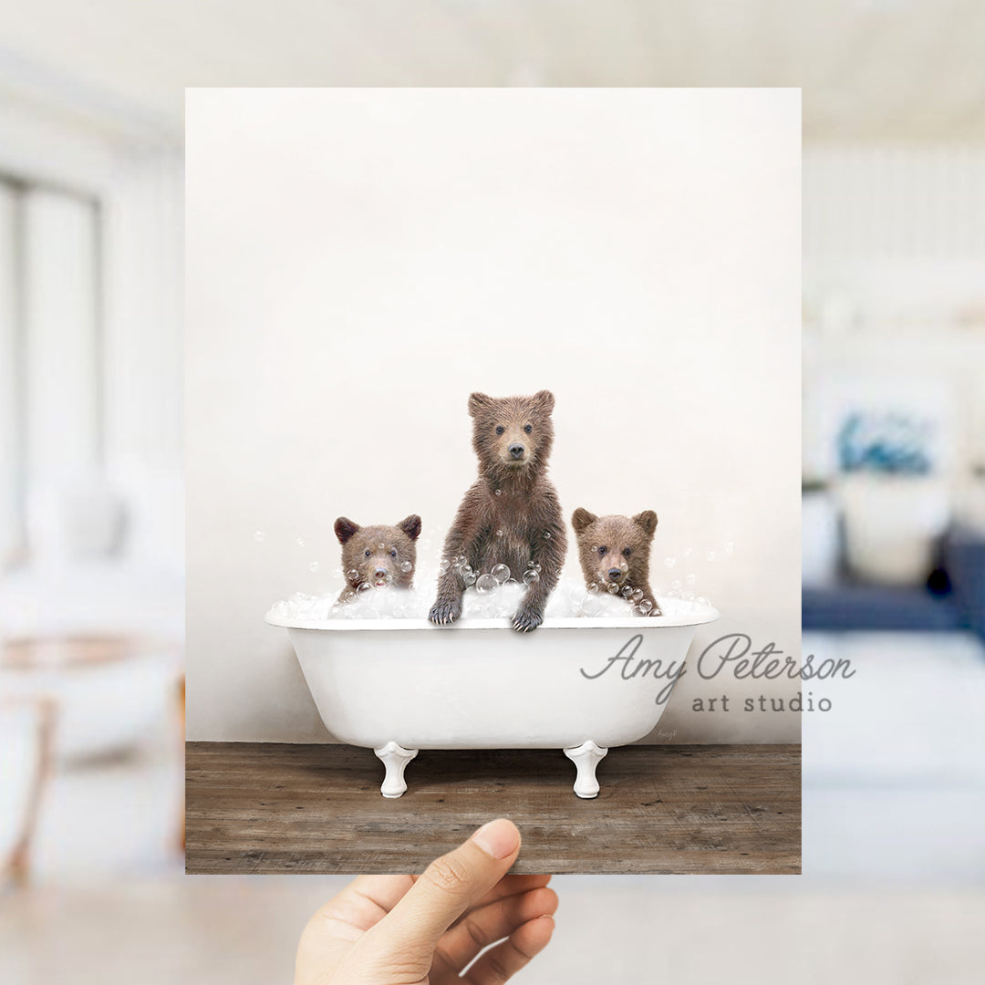 a hand holding up a card with a picture of three bears in a bathtub