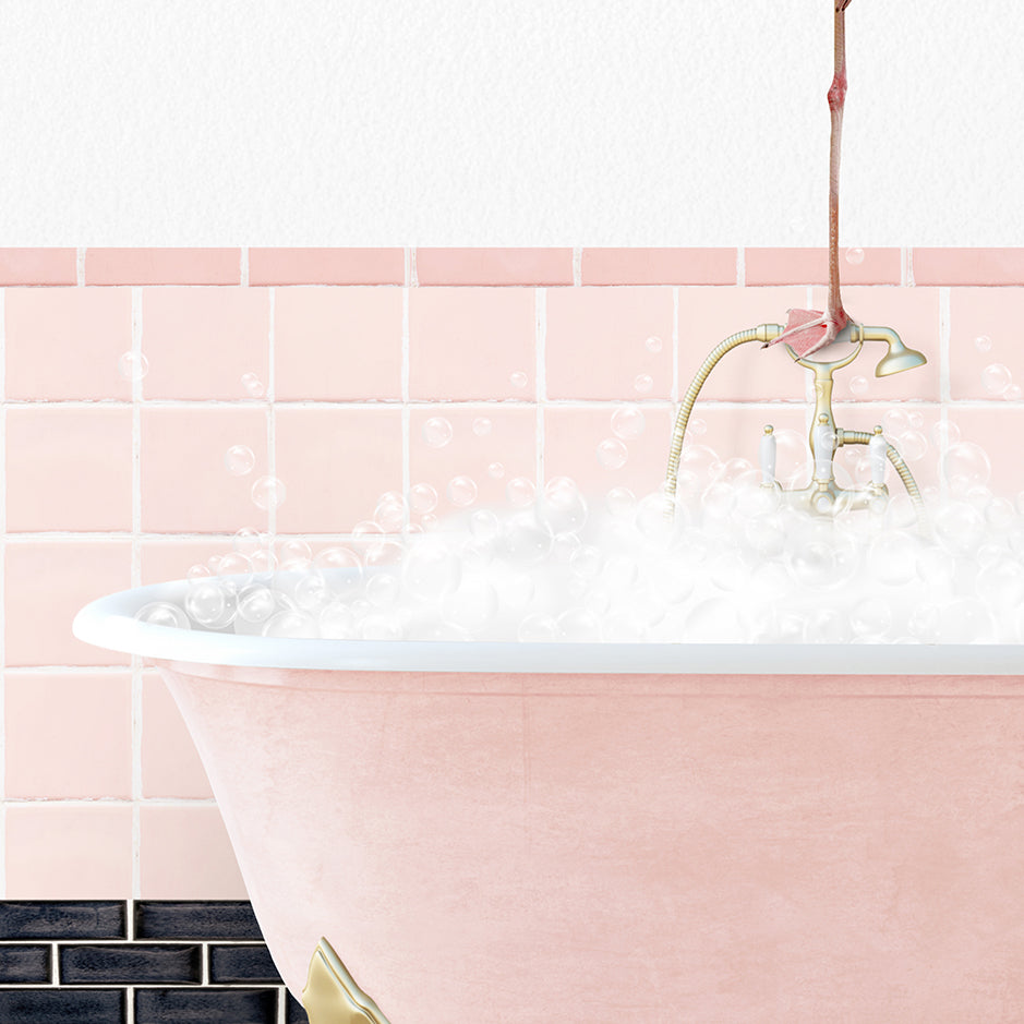 a pink bath tub filled with bubbles and a faucet