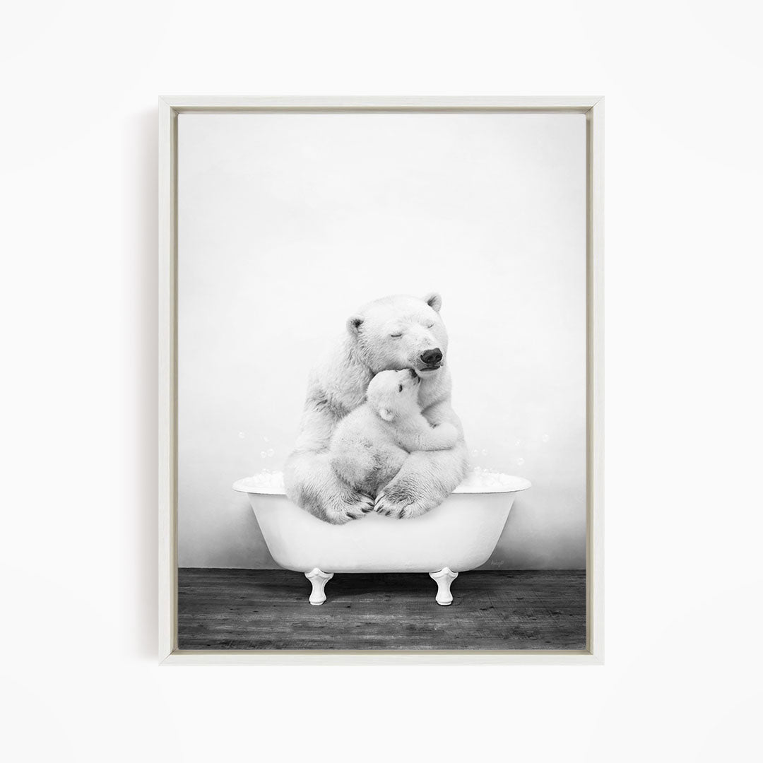 A black and white photograph of a mother polar bear sitting in a bathtub, with her cub resting on her lap.