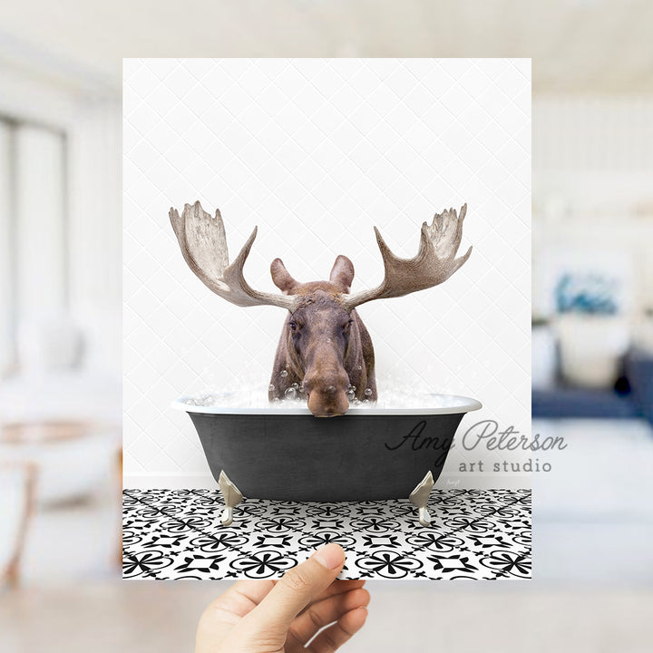 a person holding up a card with a picture of a moose in a bathtub