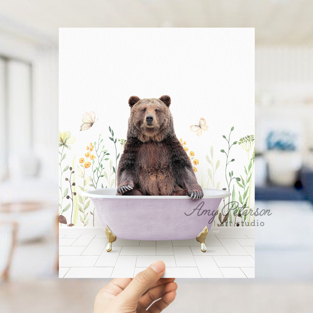 a person holding up a card with a bear in a bathtub