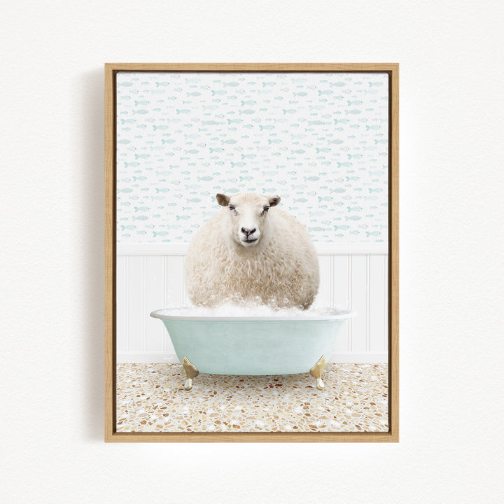 A fluffy white sheep sits in a light blue bathtub filled with bubbles, surrounded by a patterned tile floor and a white wall with a fish-themed wallpaper.