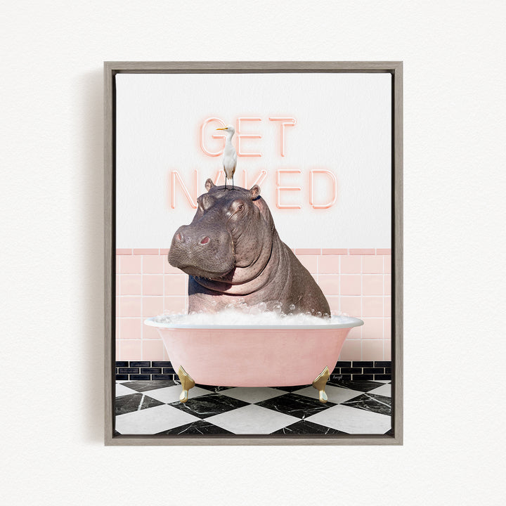 A framed image depicting a hippopotamus sitting in a pink bathtub, with a bird perched on its head. The text "GET NAKED" is displayed above the hippopotamus.